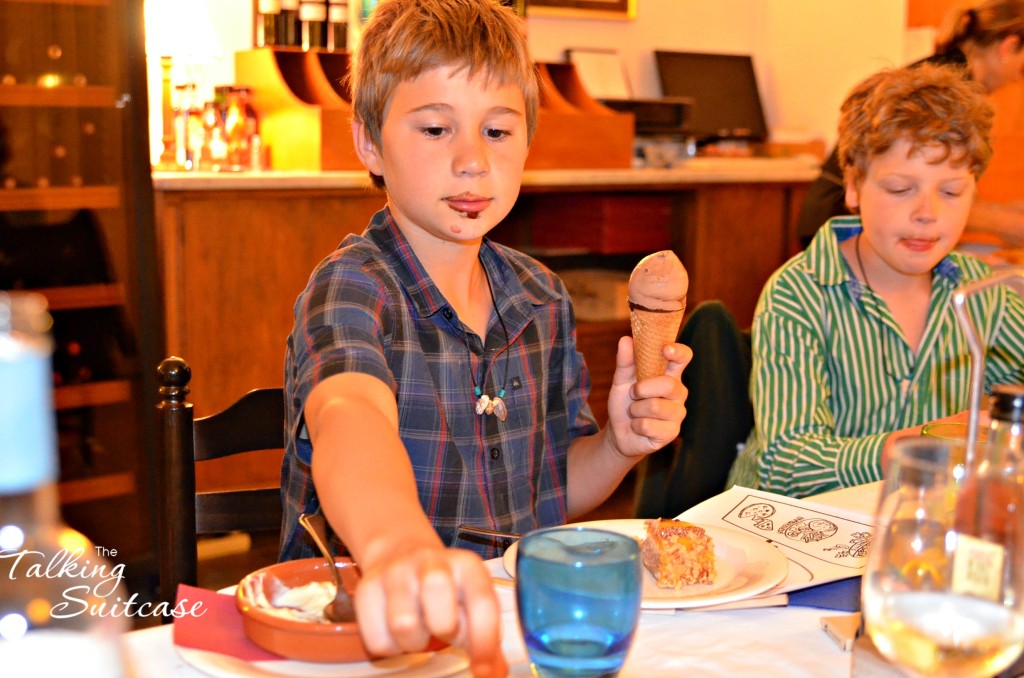 As if the ice cream in his hand isn't enough, he has cake in front of him and is reaching for another donut piece. 