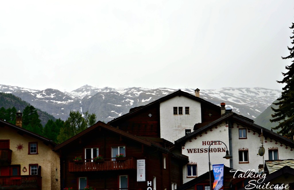 Snow covered mountains tower behind Zermatt