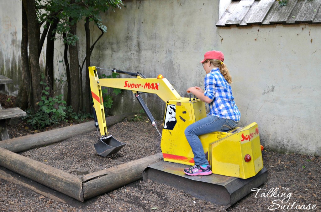 Digging fun - she's happy in a dress or on construction equipment